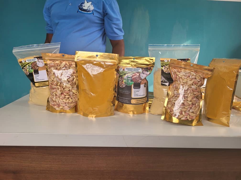 Akajuma branded gold retail pouches of powders and seeds on a table