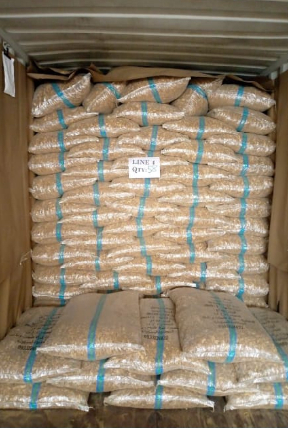Stacked bags of agricultural produce inside a shipping container